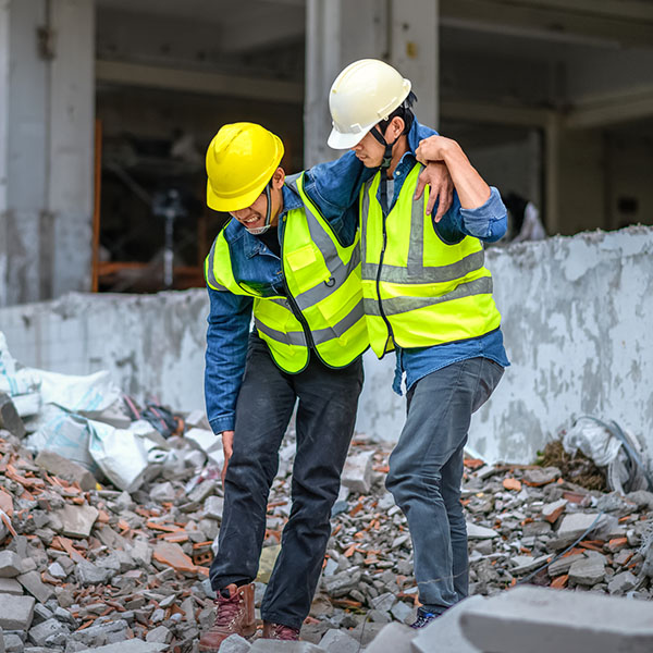 engineers help construction workers who have knee and leg injuries